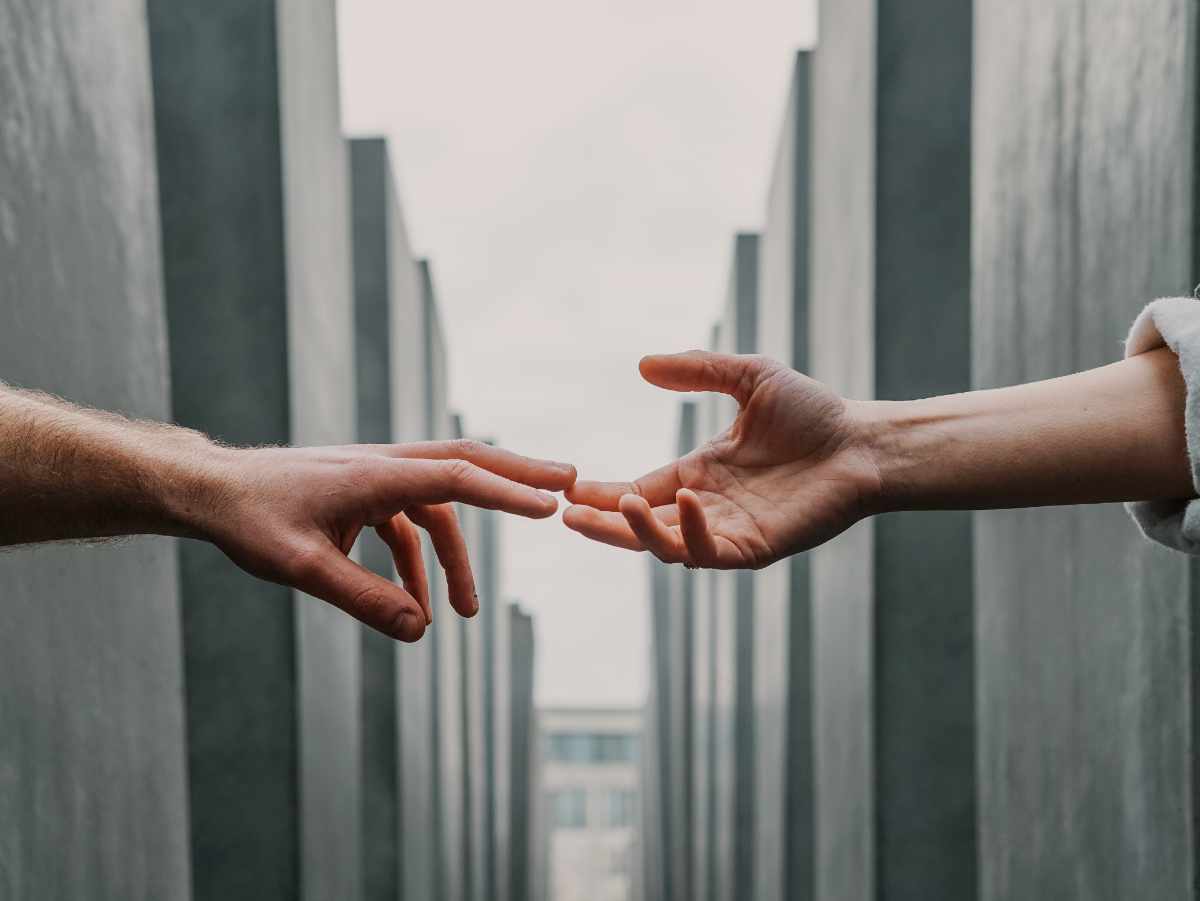 Pink clouds with a flock of birds flying through them.